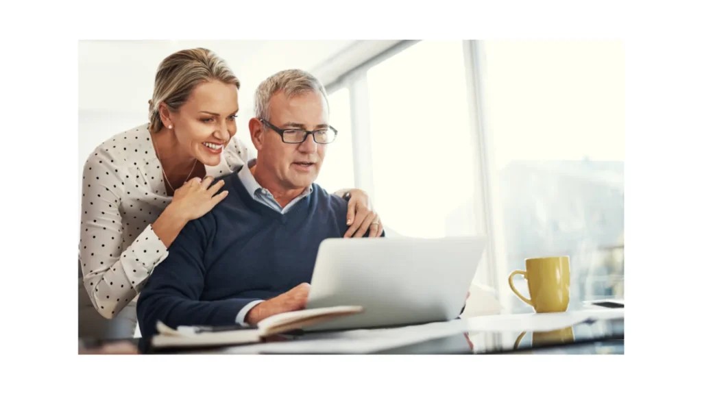 Happy senior couple using laptop, planning finances.